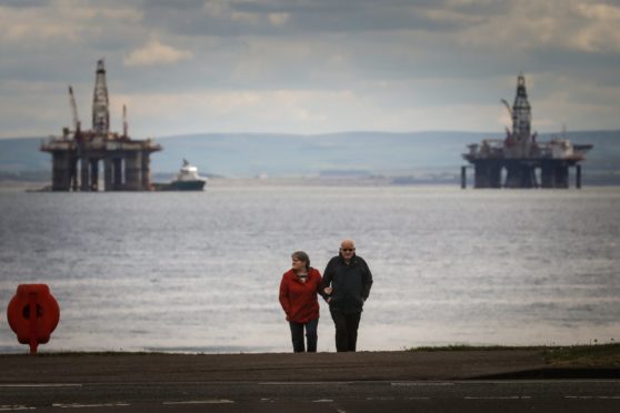 People walk on the sea front for their exercise during lockdown 2 in Leven.