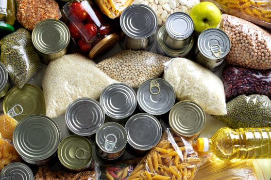 Set of raw cereals, grains, pasta and canned foods - examples of foods donated to community fridges