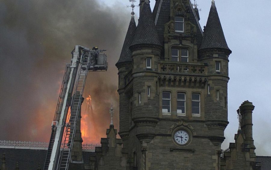 The fire quickly consumed the roof of the historic Morgan Academy building.
