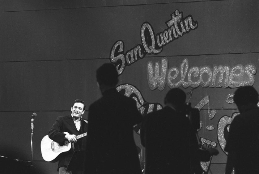 Johnny Cash performing at San Quentin during one of his famous concerts.