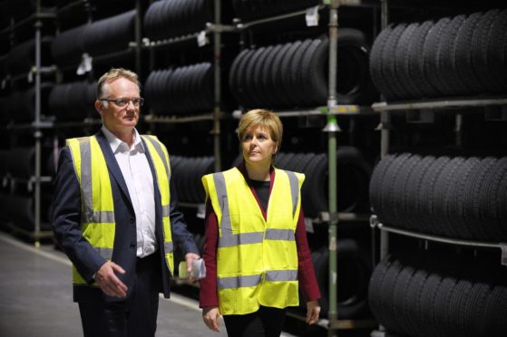 First Minister of Scotland Nicola Sturgeon is shown around Michelin by manager John Reid.