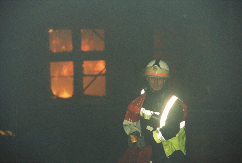 Firefighter Eddie Lynch works at the scene of the Morgan Academy fire.