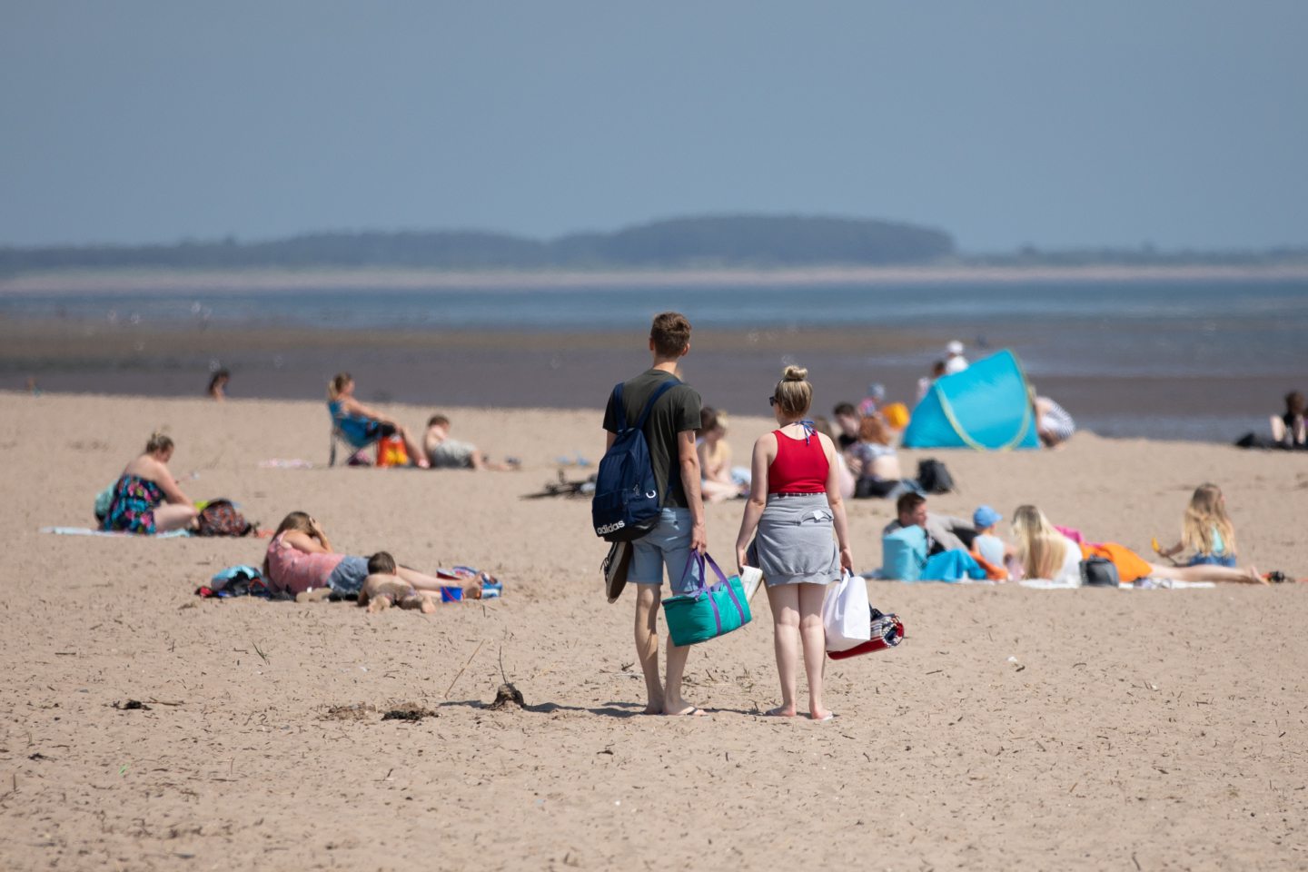 A couple looking for a place to sit on a busy Broughty Ferry beach