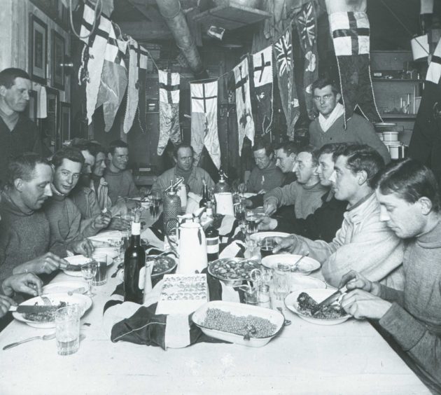 Captain Scott celebrating his final birthday in the Terra Nova hut on Ross Island at Cape Evans.