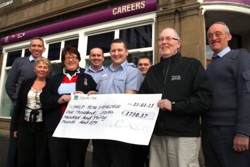 Tim Grantham receives a Help for Heroes cheque from the he RAF Careers Office, Bank Street, Dundee in 2011