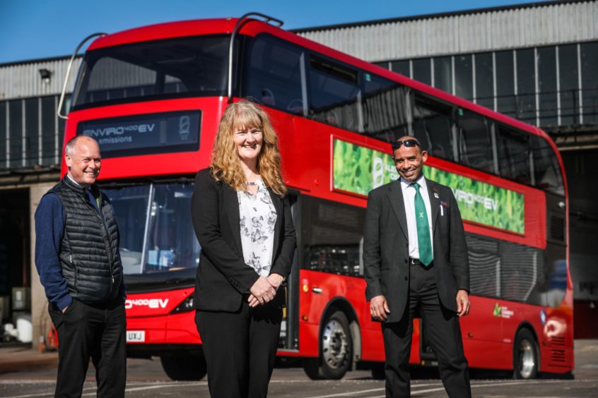 Keith Watson, Christine McGlasson and Johnathan Eggleton standing next to an electric bus bound for Lochee Road