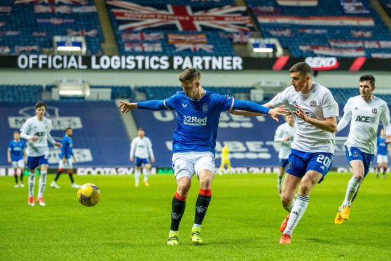 Cedric Itten of Rangers shields the ball from Ross Graham of Cove Rangers.