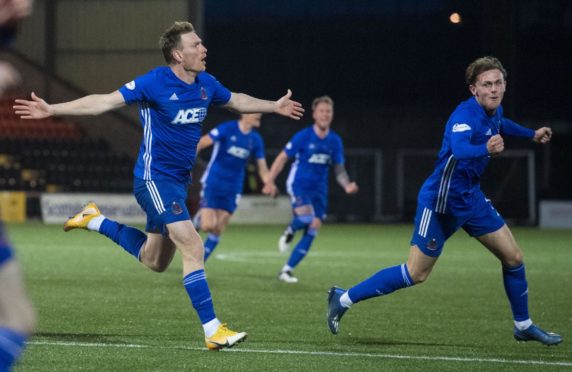 Cove's Rory McAllister (L) celebrates making it 2-1.