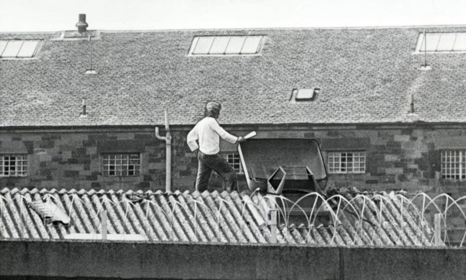 Mone on top of the wash house roof in 1981 during his protest against his conditions. Image: DC Thomson.