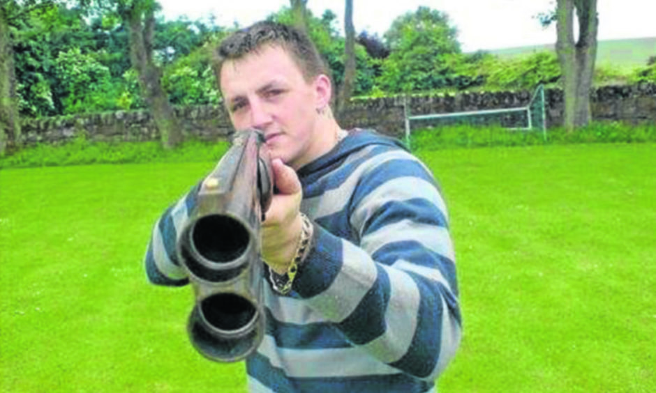 Dennis Cox with a gun