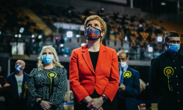 Nicola Sturgeon standing with her campaign team during the 2021 election in Glasgow.