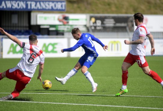 Cove's Seb Ross strikes at goal.