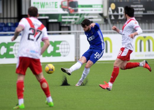 Cove's Daniel Higgins hits the post.