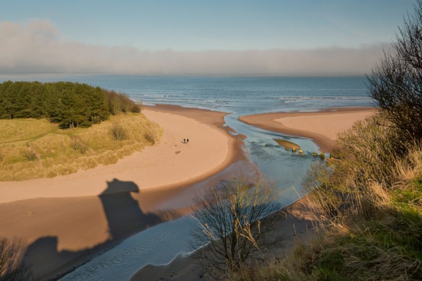 The shadow of Redcastle on the sands at the mouth of the River Lunan.