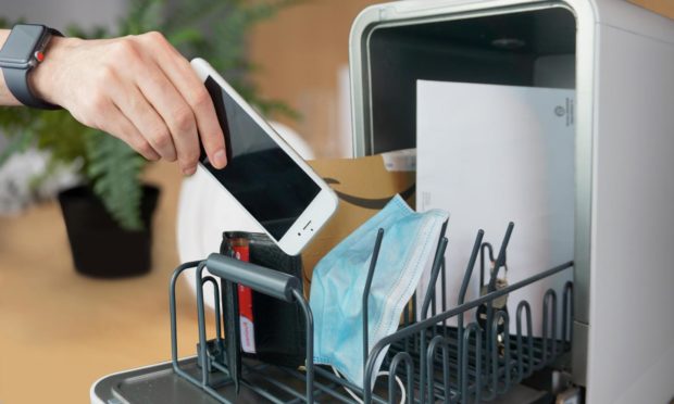 The dishwasher can disinfect and sanitise personal items such as phones, keys and wallets.