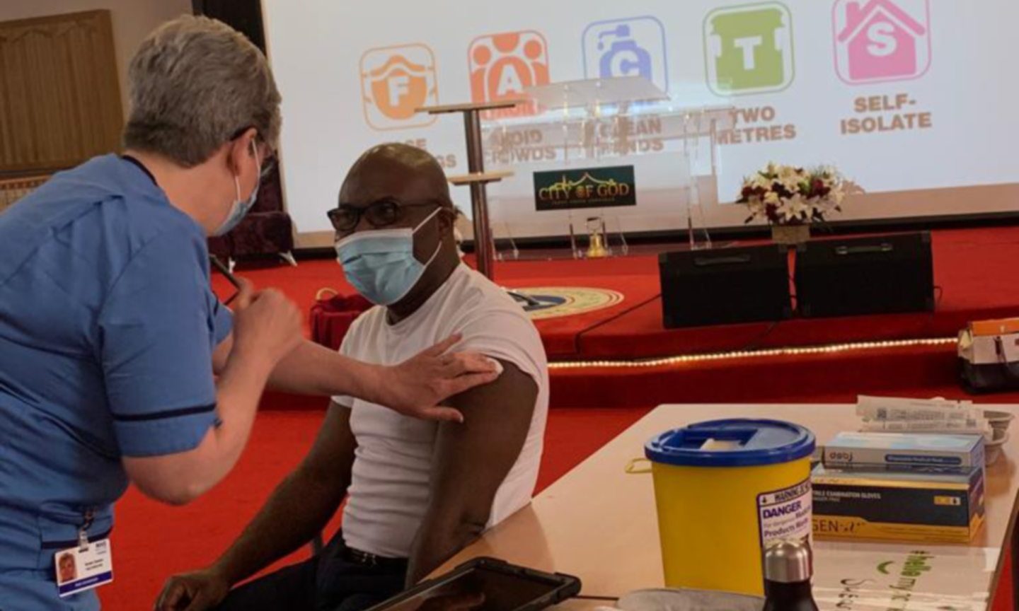 Pastor Joe Ochei is vaccinated at City Of God church in Aberdeen.