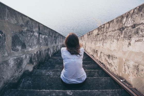 Woman alone staring into distance