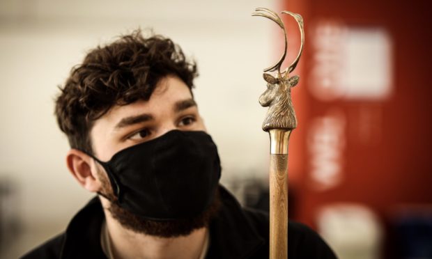 Ben Marshall with one of his stag's head walking sticks.