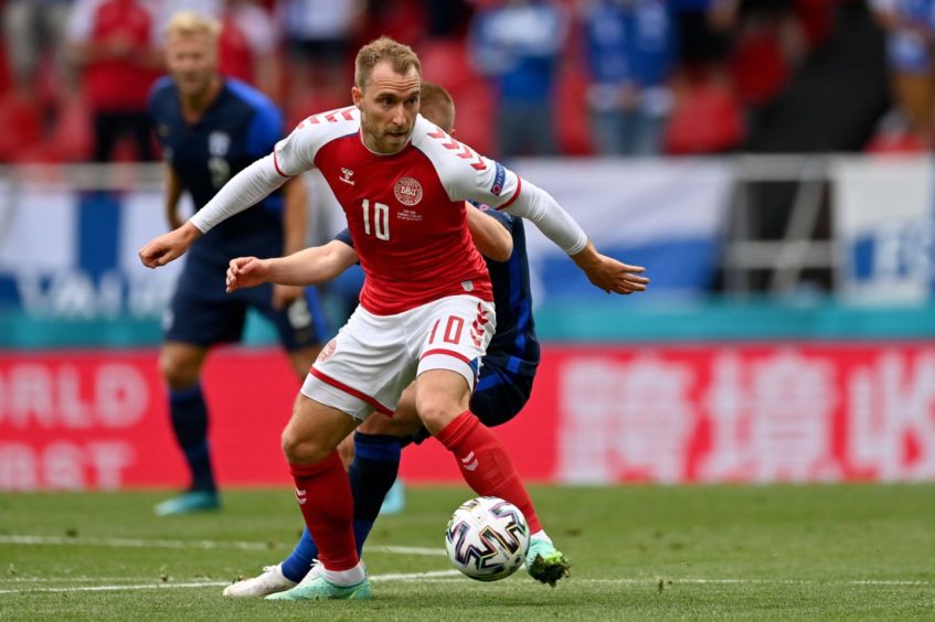 Christian Eriksen controlling a ball while playing for Denmark.