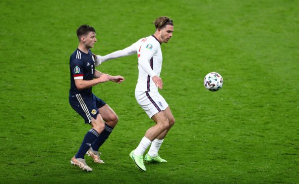 Jack Grealish upon against Scotland defender Kieran Tierney.