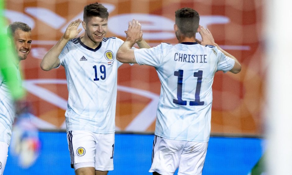 Kevin Nisbet celebrates his goal against Netherlands with Ryan Christie.