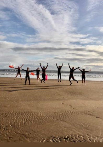 The Good Vibes Tribe swimming group celebrating another wild swim.