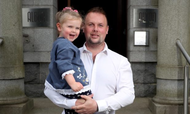 New owner of The Albyn, Simon Cruickshank, and his three-year-old daughter, Sienna, on the terrace.