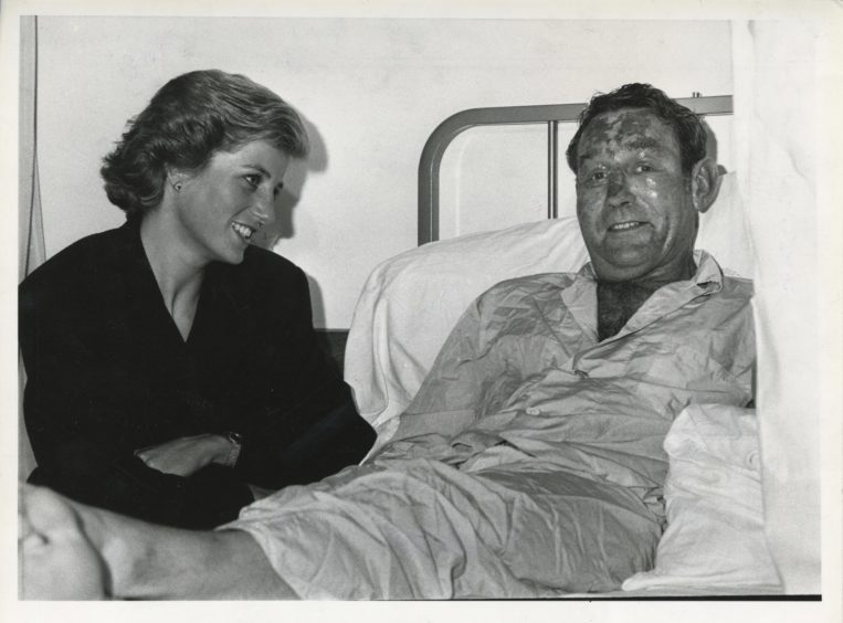 The Princess of Wales meeting survivor Michael Bradley in a hospital in Aberdeen in 1988.