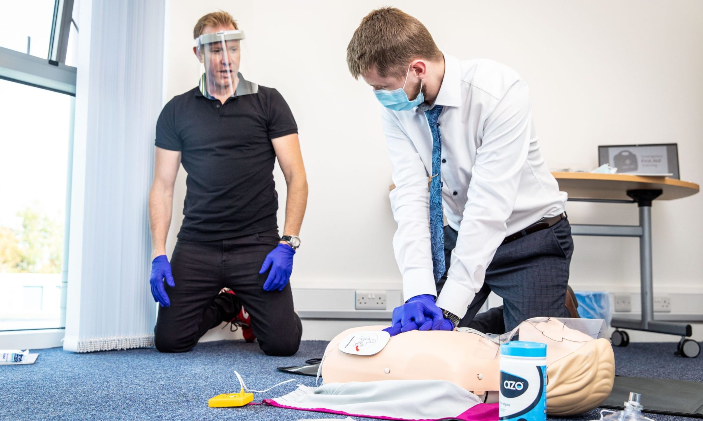 Save Harber holds a training course on First Aid, demonstrating CPR procedures.