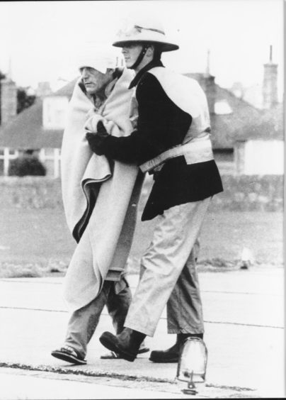 An injured worker being taken to Aberdeen Royal Infirmary following the  North Sea oil rig explosion in 1988.