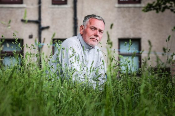 Neil McLaren in the overgrown grass