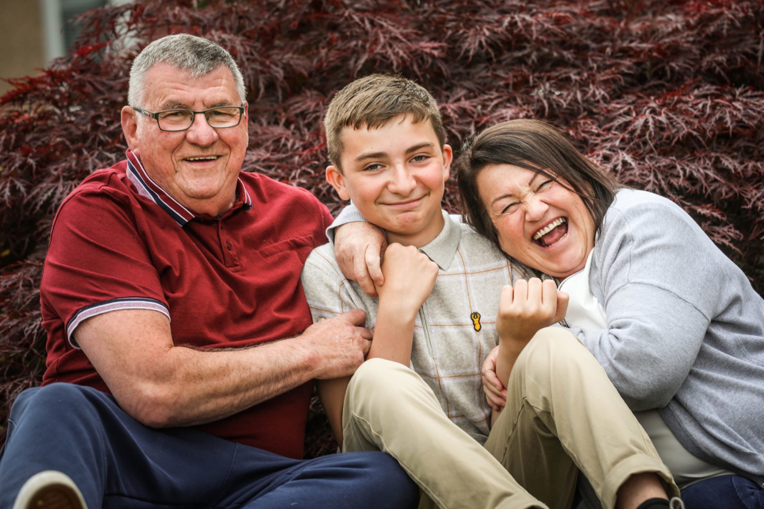 A thirteen year-old boy having fun with his foster parents