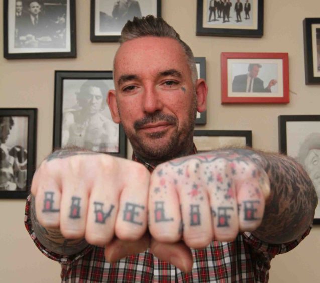steve barnes with "live life" on his knuckles