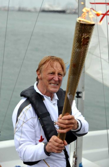 Rodney Pattisson with the Olympic torch.