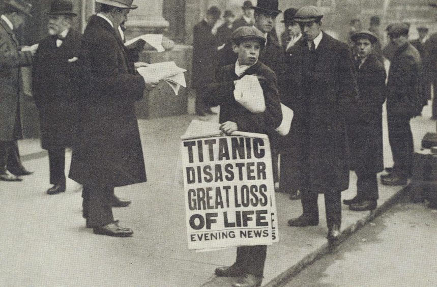 London newspaper seller with banner announcing the loss of SS Titanic in 1912.