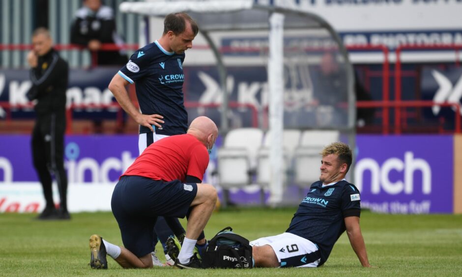 Dundee FC player Mullen receives treatment against St Mirren.