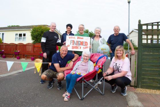 Derek, from Montrose, with family and friends outside his mum's house, celebrating the completion of his 50 mile walk.