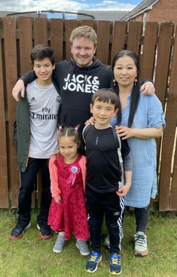 Chris and his wife Papi, whom he met at work, with their children, Daniel, Sion and Kikka.