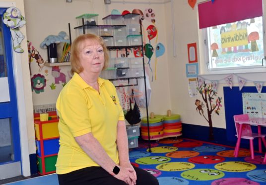 Kiddiwinks manager Carolyn Harper sitting on the floor of the playgroup