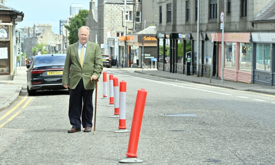 Councillor Bill Cormie in Rosemount Place, next to Spaces For People bollards.