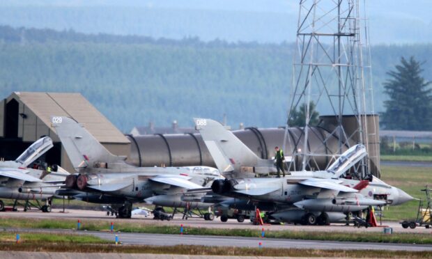 Air ground crew work on Tornado planes at RAF Lossiemouth, following the 2012 collision.