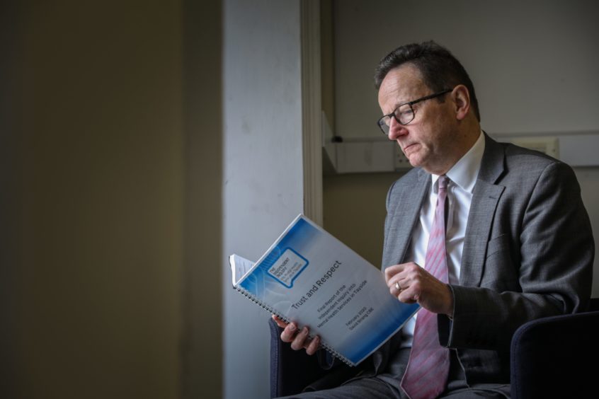 David Strang looks over the original report from 2020