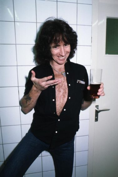 Bon Scott enjoying a drink at the height of his success with AC/DC.