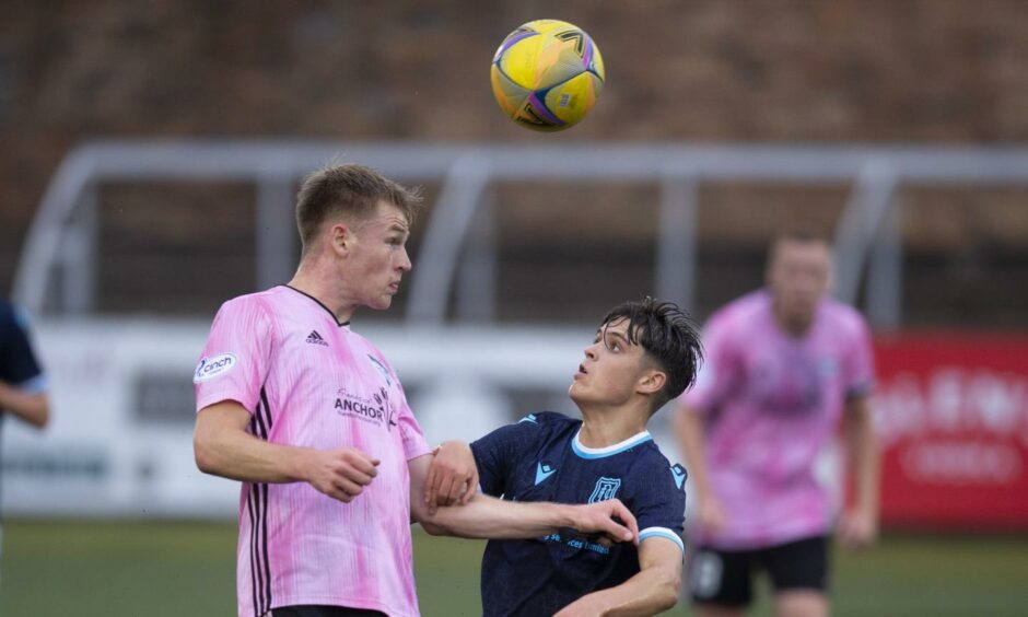 Dundee B v Peterhead: Hamish Richie of Peterhead competes in the air with Callum Lamb of Dundee.