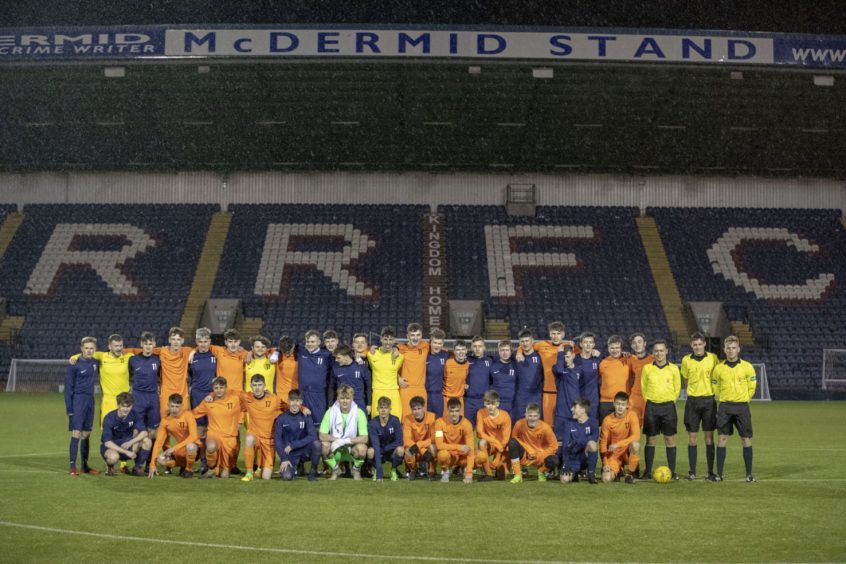 The teams line up for a team photo before kick off.