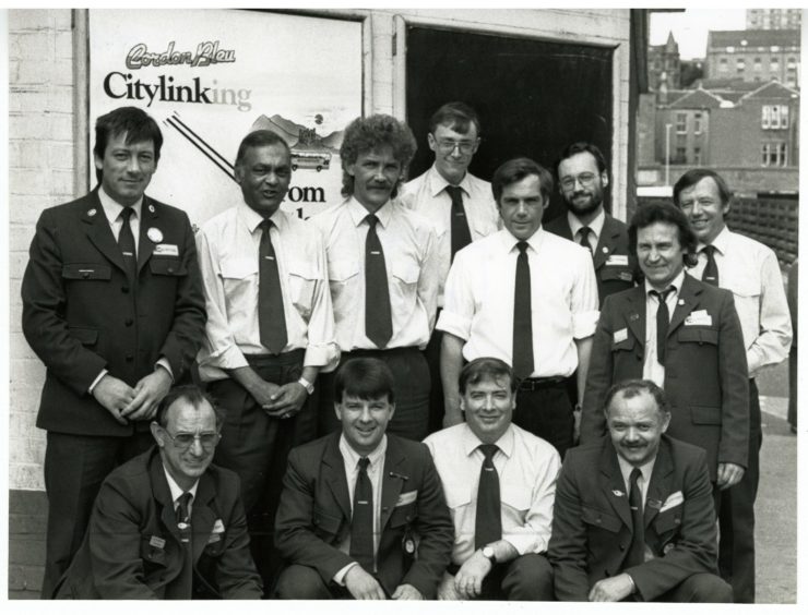 a group of drivers, conductors and inspectors are pictured at the Seagate bus station in June 1988
