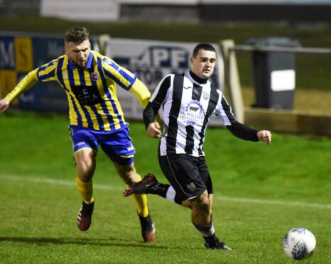 Inverurie Locos defender Mark Souter (left) challenges Fraserburgh forward Scott Barbour.