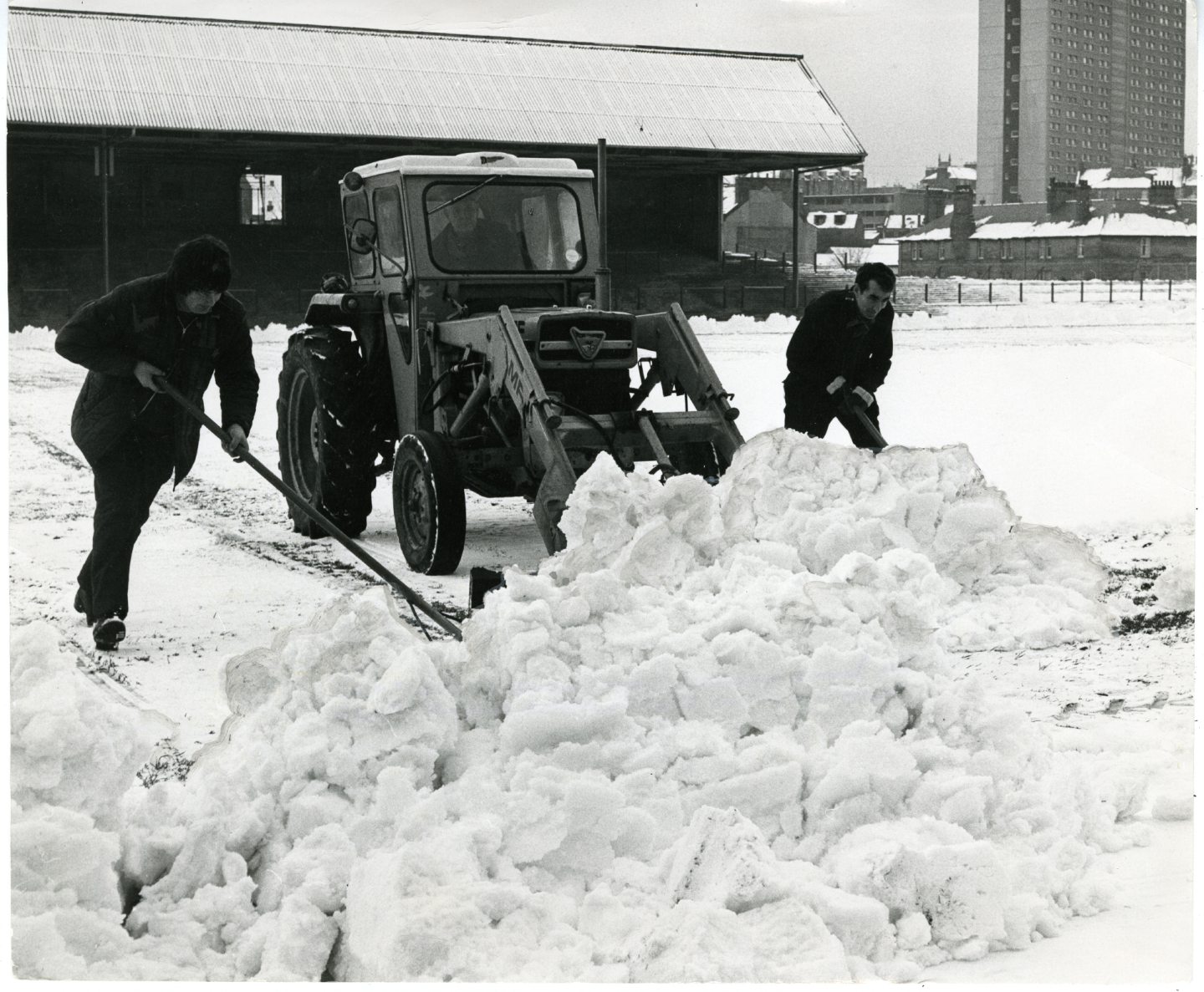 Des ouvriers dégagent une neige abondante à Dens Park pour un prochain match contre le Celtic en décembre 1974. Le stade a été équipé d'un chauffage par le sol en 2005.