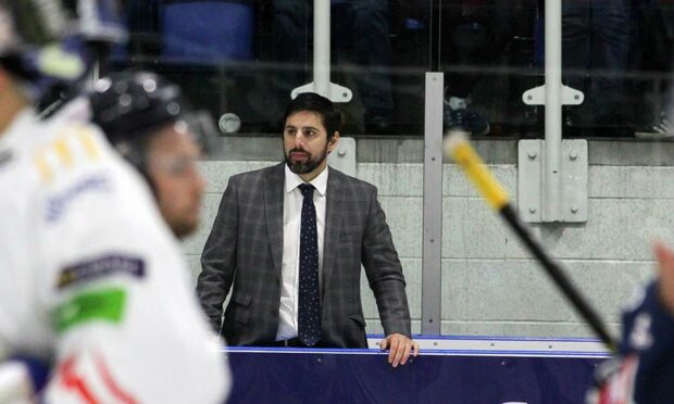 Dundee Stars head coach Omar Pacha on the side of the ice rink.