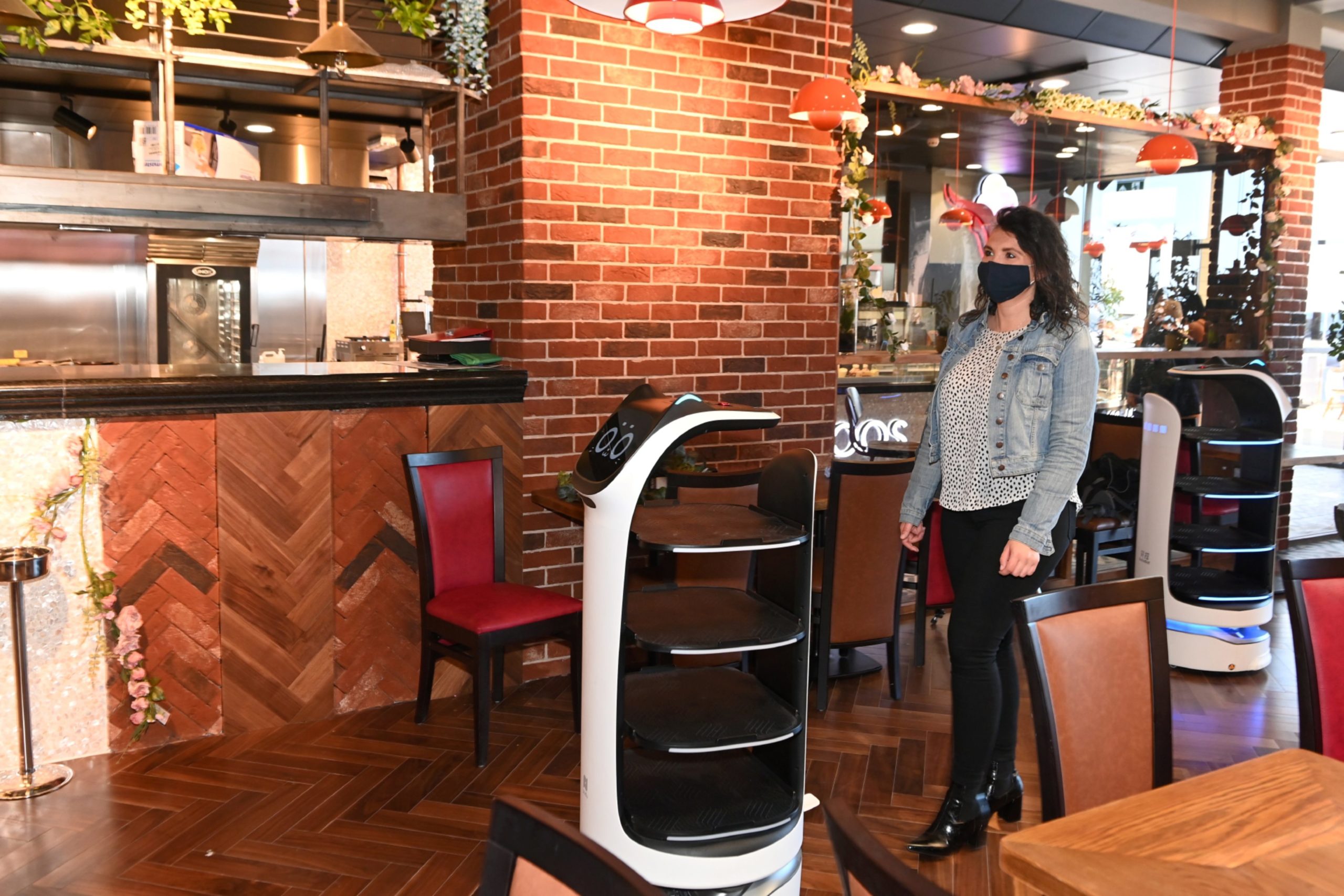 Food and Drink Journalist Julia Bryce with one of the robot waiters. 